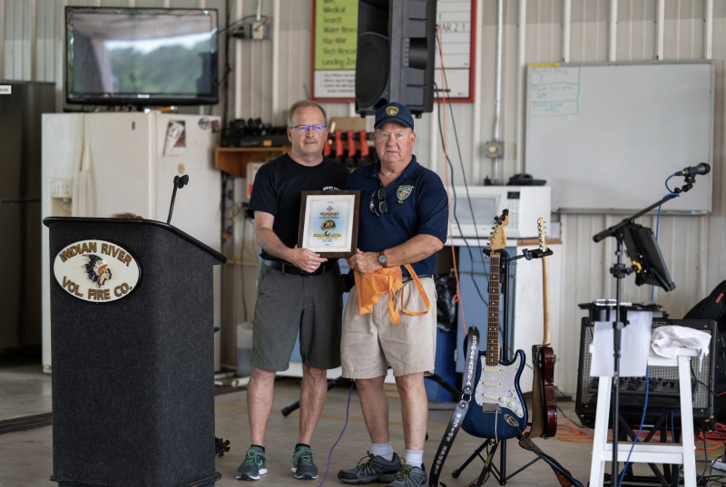 Ellendale Volunteer Fire Company member Ted Wallus, right, presents Indian River Volunteer Fire Company President Patrick Miller with a plaque.